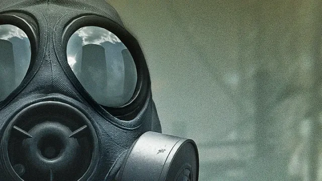 Close-up of an operator in a gas mask, a city skyline reflected in the lenses