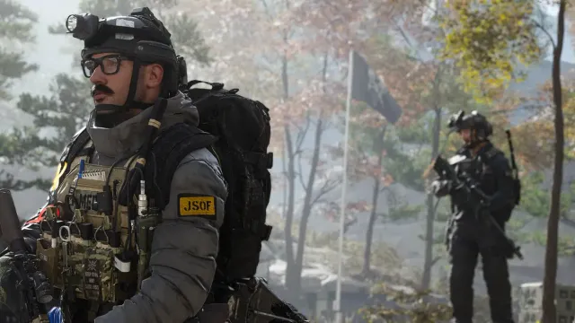 An operator in heavy operator gear carrying a pack